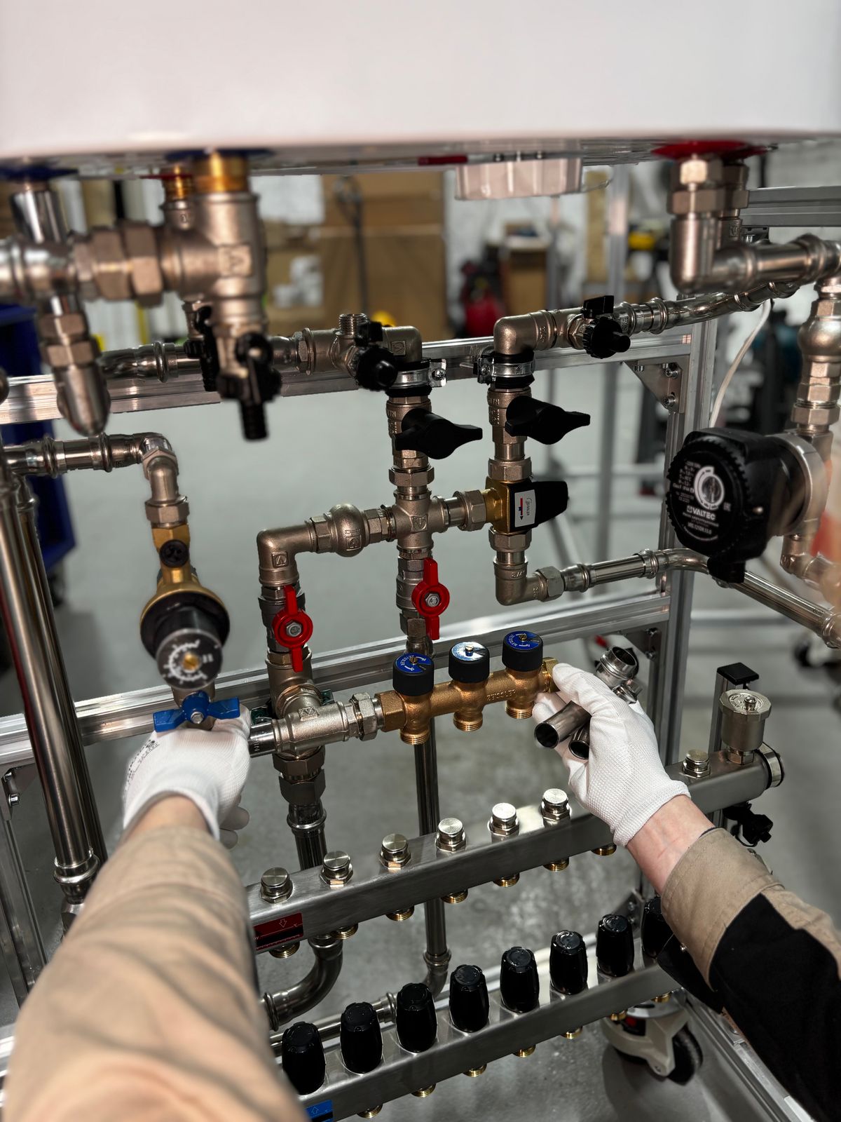 Plumber working on a valve and manifold assembly