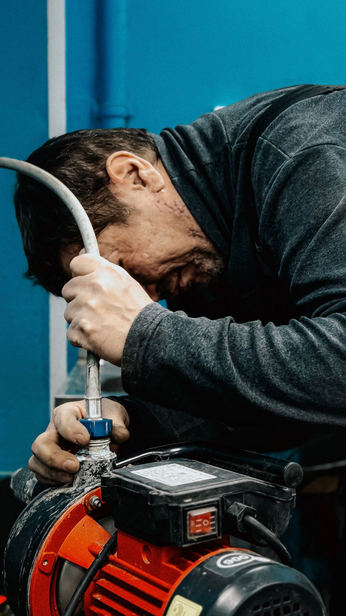 Plumber servicing a water pump