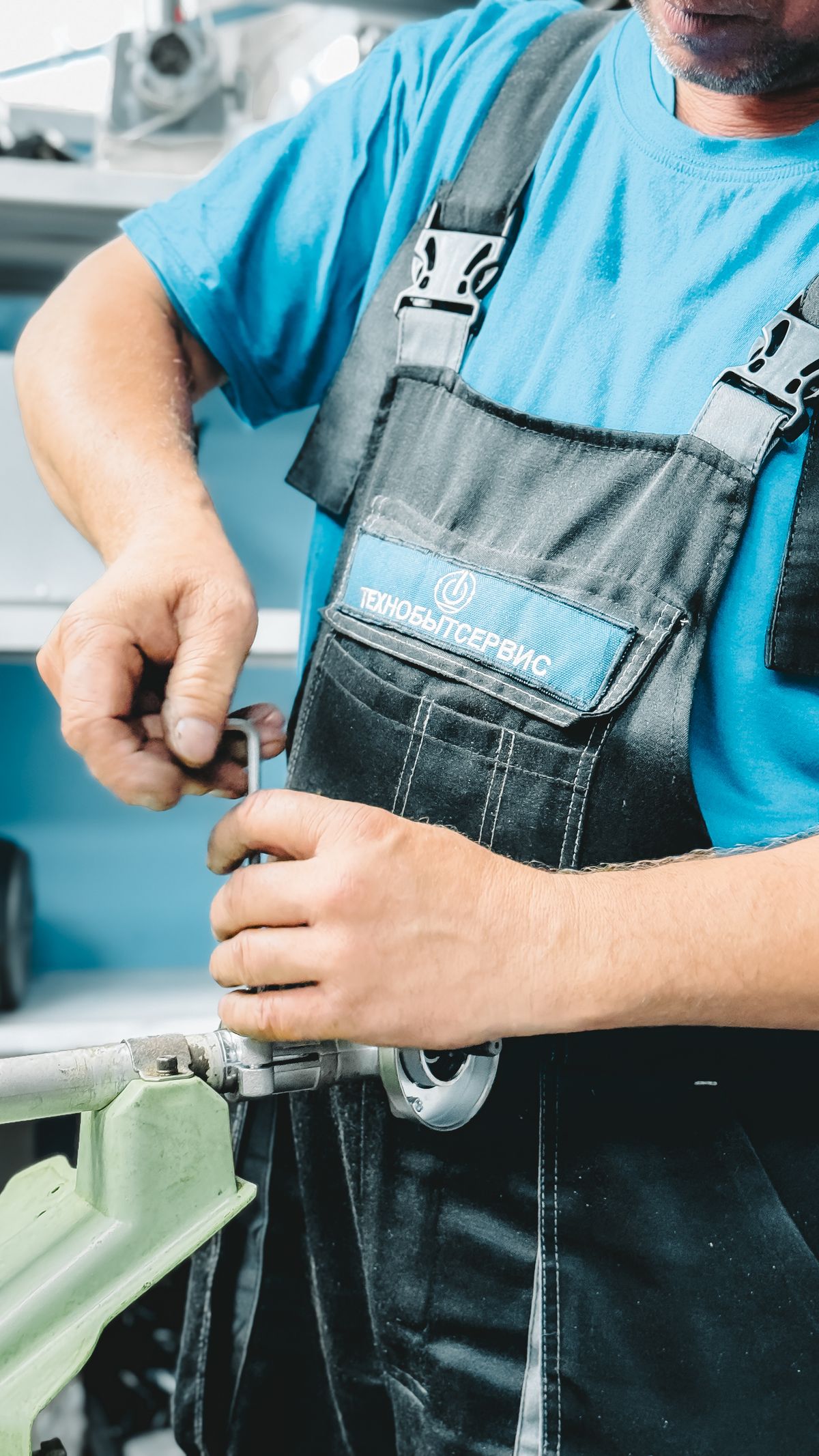 Gloved plumber fitting a threaded pipe connection